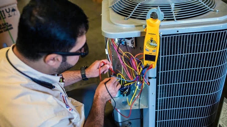 Close-up of HVAC electrical testing with a clamp meter